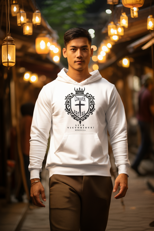 Christian T Shirt. Man wearing a white Christian hoodie with a Conquer and Prevail logo in an outdoor setting with warm lighting